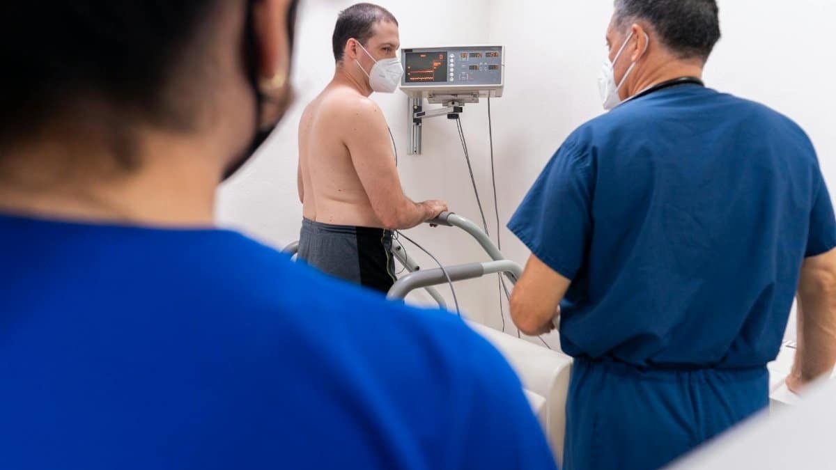 Patient undergoing a cardiology stress test with doctors monitoring in a clinic.