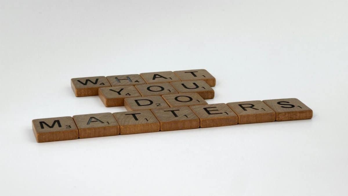 Scrabble tiles form the motivational phrase 'What You Do Matters' on a white background.