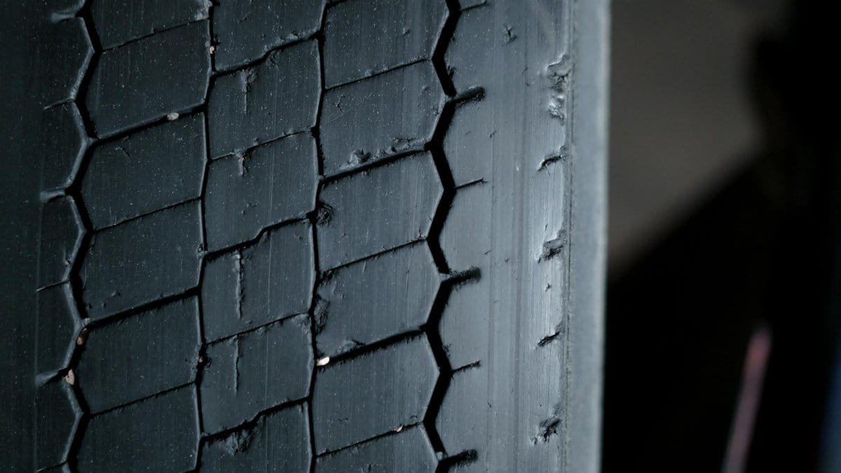 Detailed close-up of a worn tire tread showcasing grooves and patterns.