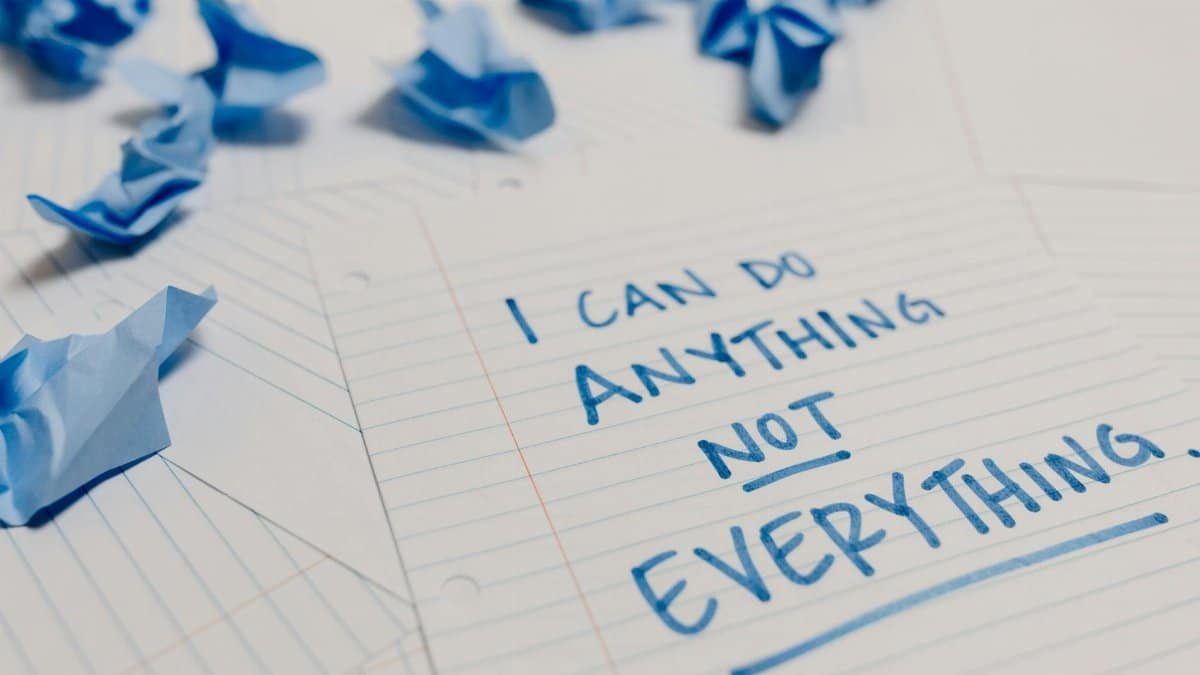 Handwritten motivational quote on lined paper with crumpled notes around, emphasizing self-empowerment.