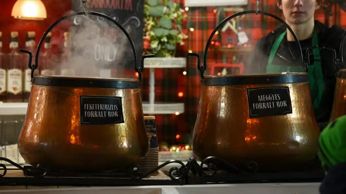 Steam rises from copper pots of mulled wine at a market stall in Debrecen, Hungary.