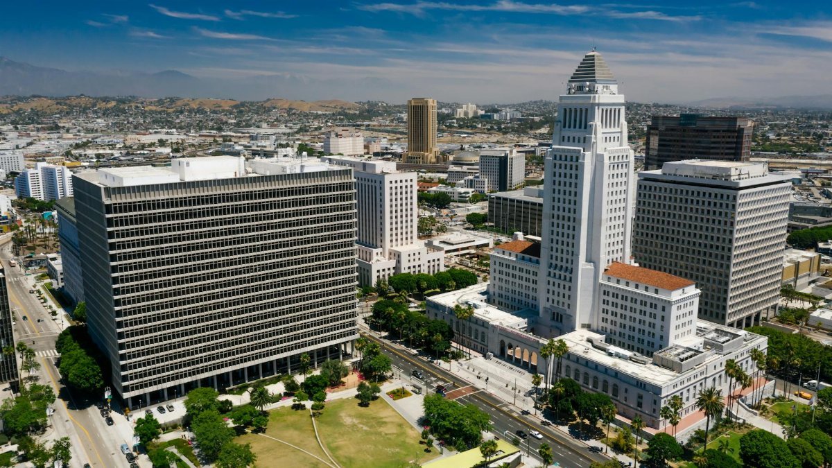 Stunning aerial view of downtown Los Angeles featuring the iconic City Hall and urban skyline.