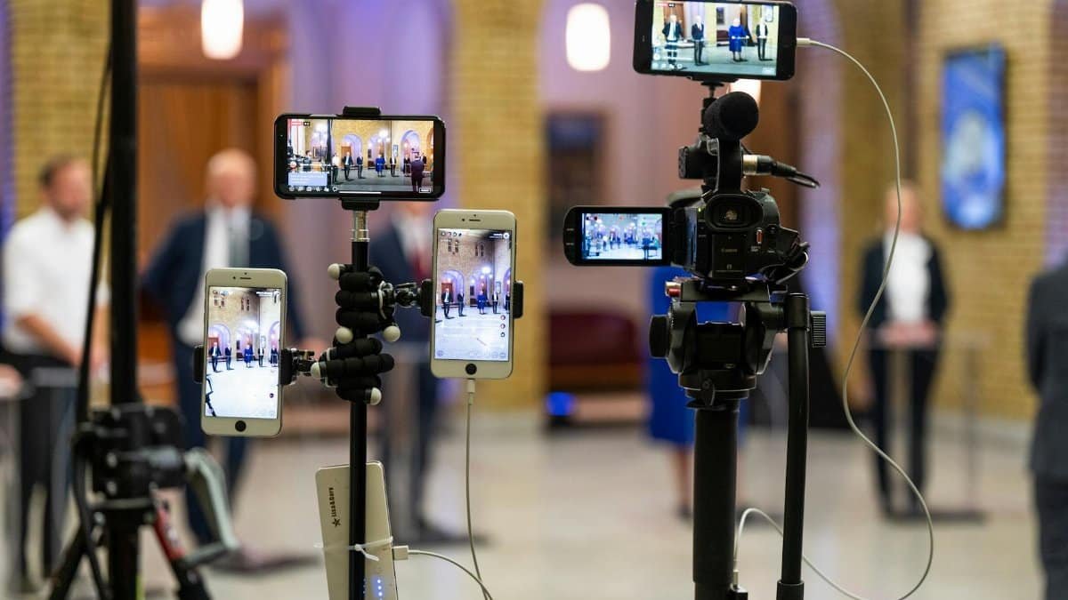 Multi-camera setup capturing a live event indoors, showcasing modern filming technology.