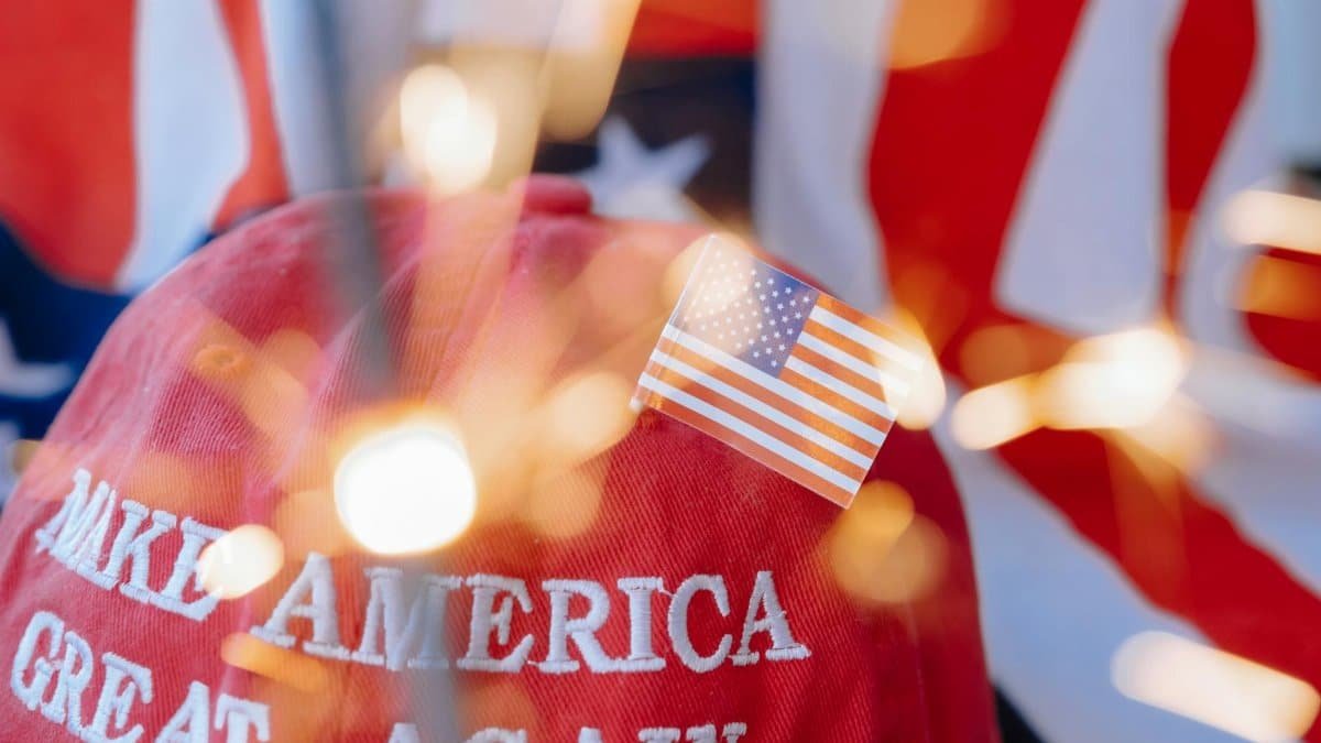 Close-up of a red cap with 'Make America Great Again' and a small American flag.