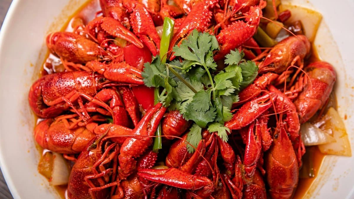 A vibrant plate of spicy crawfish garnished with fresh cilantro, ready to savor.