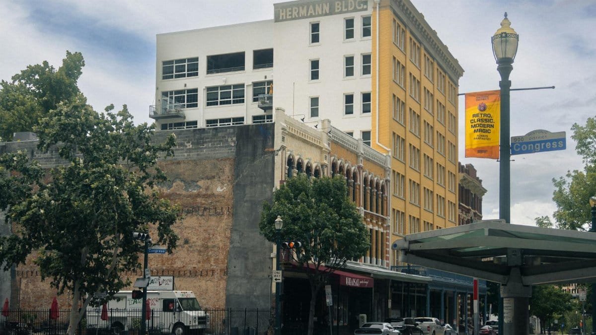 Scenic view of historic buildings in downtown Houston, showcasing urban architecture on a sunny day.