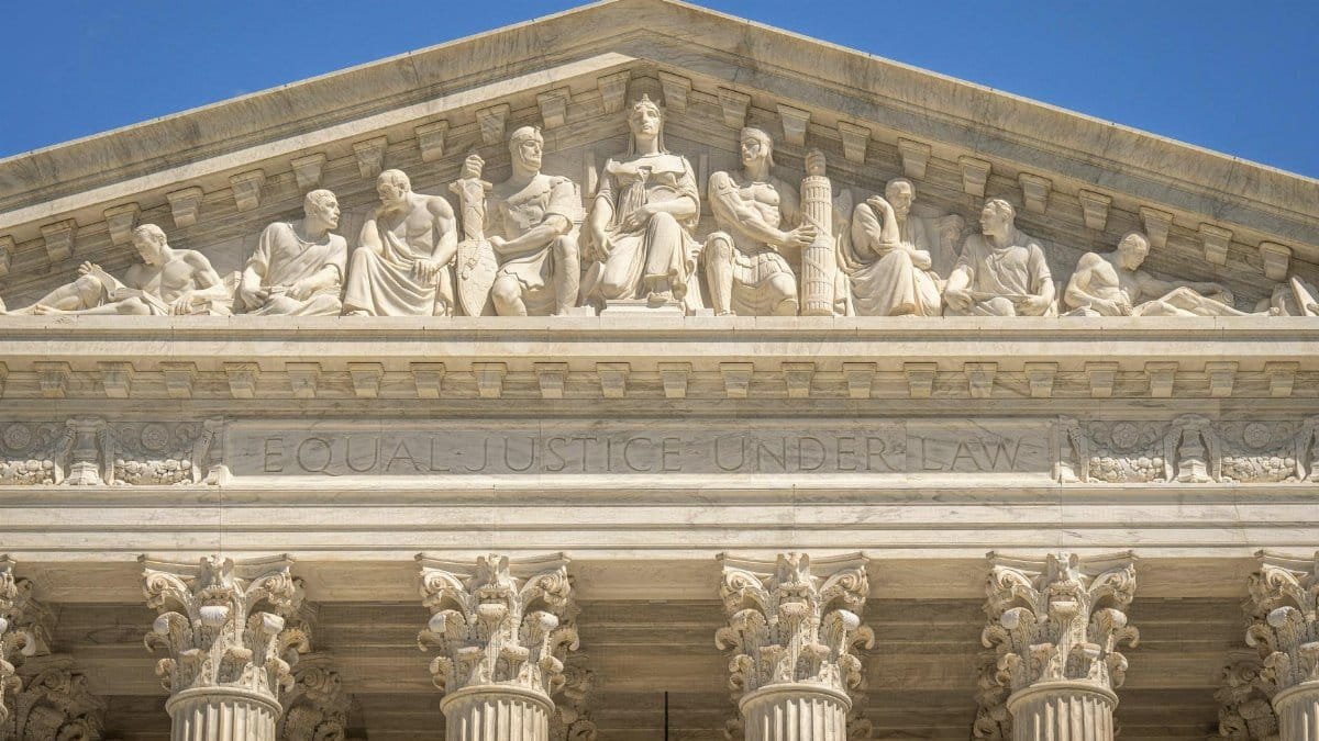 Detailed view of the Supreme Court Building's frontal frieze depicting historical figures and justices.