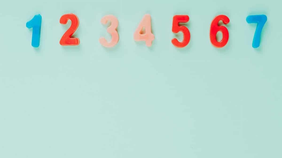 Bright plastic numbers on a blue background with ample copy space, ideal for educational themes.