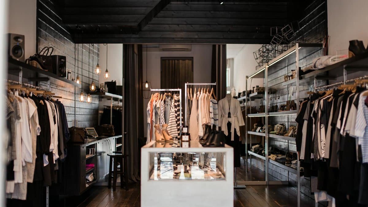 Explore the chic interior of a modern fashion retail store with clothing displays.