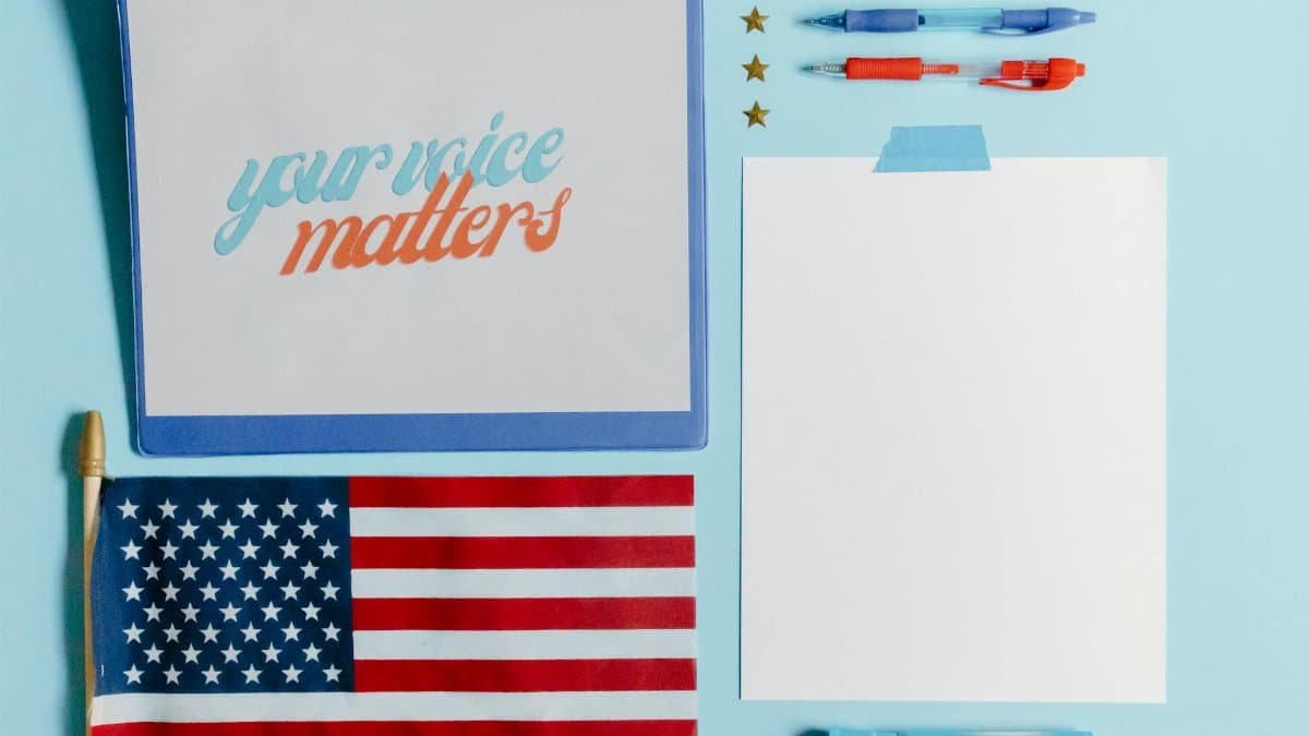 Patriotic flat lay featuring an American flag and a motivational 'Your Voice Matters' card.