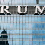 Close-up of Trump Tower's glass facade with the city skyline reflection in the windows.