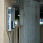 A security device mounted in a parking garage enhances safety and connectivity.