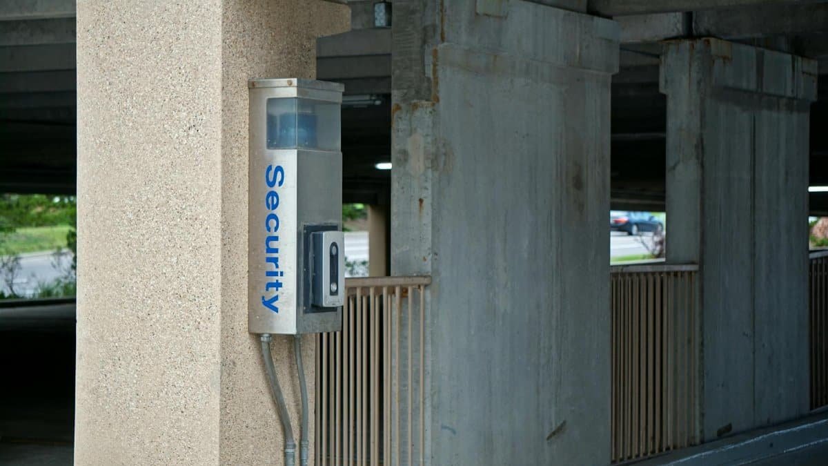 A security device mounted in a parking garage enhances safety and connectivity.