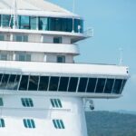 A detailed view of a cruise ship with clear skies, highlighting its design and architecture.
