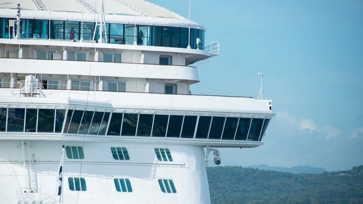 A detailed view of a cruise ship with clear skies, highlighting its design and architecture.