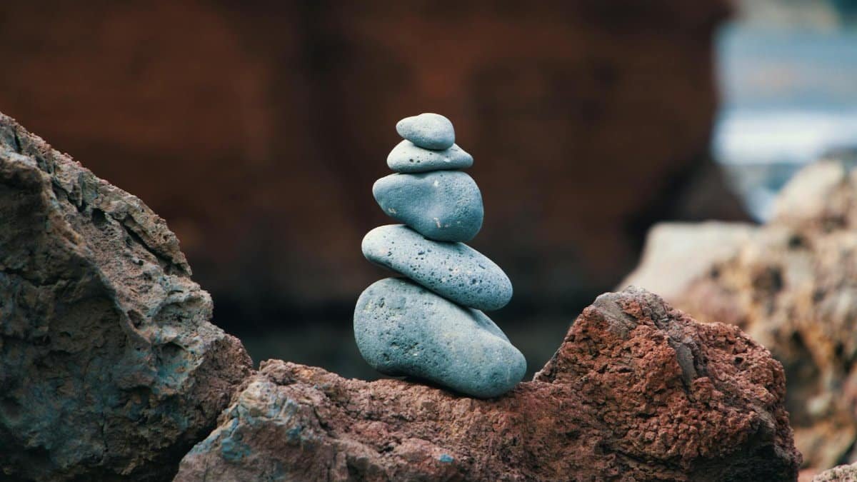 Peaceful arrangement of balanced stones in an outdoor rocky setting, symbolizing harmony.