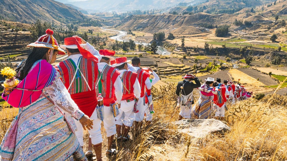 Vibrant Andean festival in Cayma, Peru with locals in traditional costumes celebrating cultural heritage.