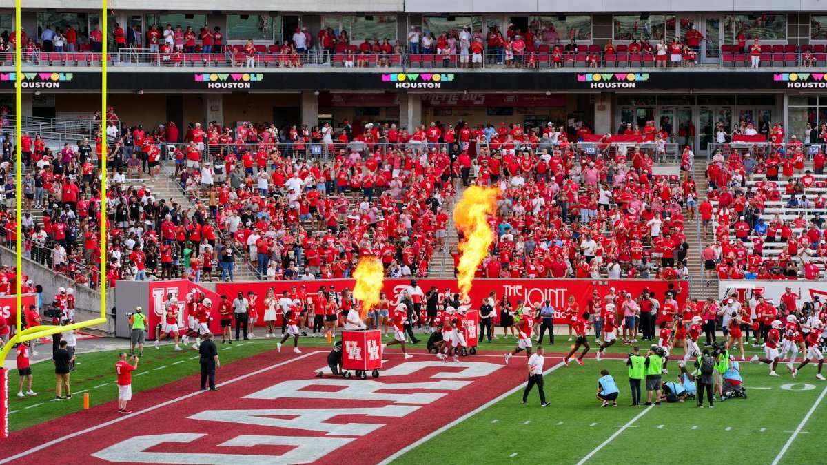 Houston college football match with vibrant crowd and fire effects. Captures the sports spirit.