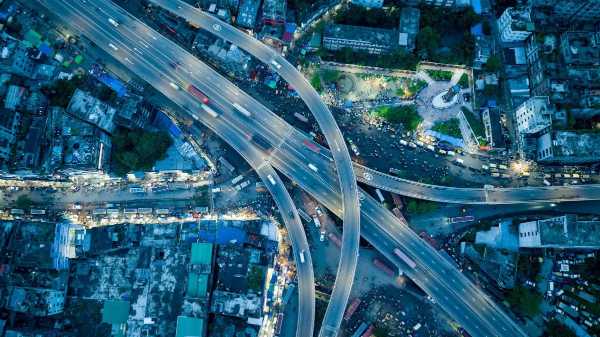 Stunning aerial shot of a bustling city highway interchange captured at twilight.