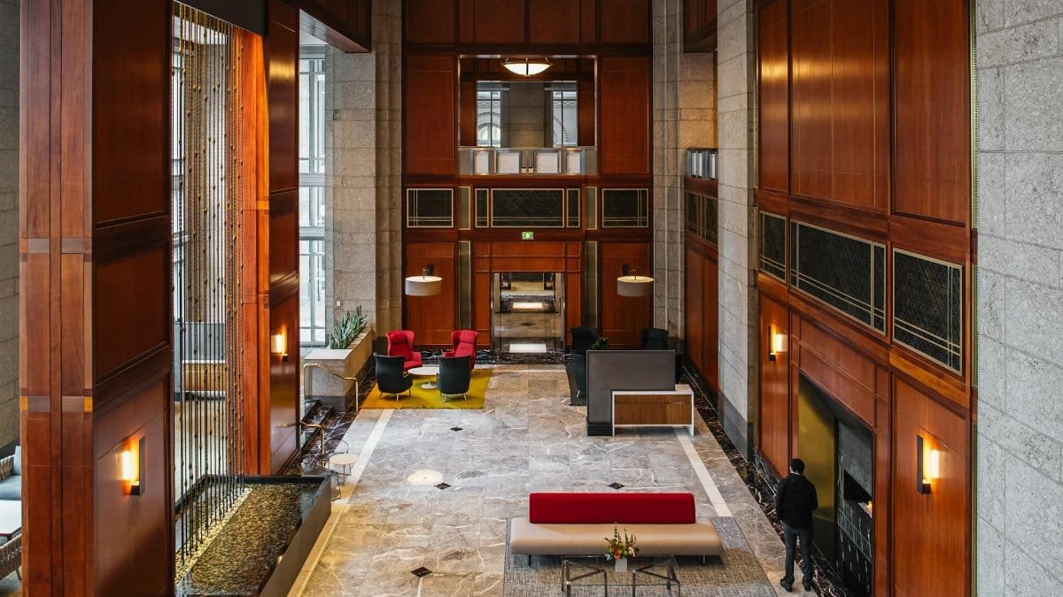 Spacious and modern office atrium featuring rich wood paneling and contemporary design elements.
