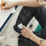 A student using hidden notes to cheat during an exam, showcasing academic dishonesty.