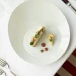 Top view of gourmet French cuisine in a fine dining setup, Vonnas, France.
