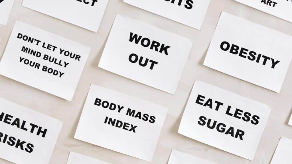 Flat lay of motivational health quotes on paper, promoting healthy habits and self-care.