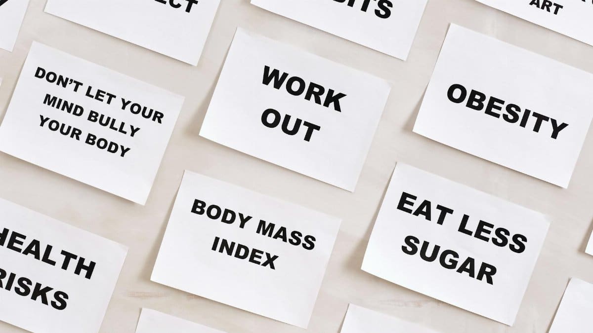 Flat lay of motivational health quotes on paper, promoting healthy habits and self-care.