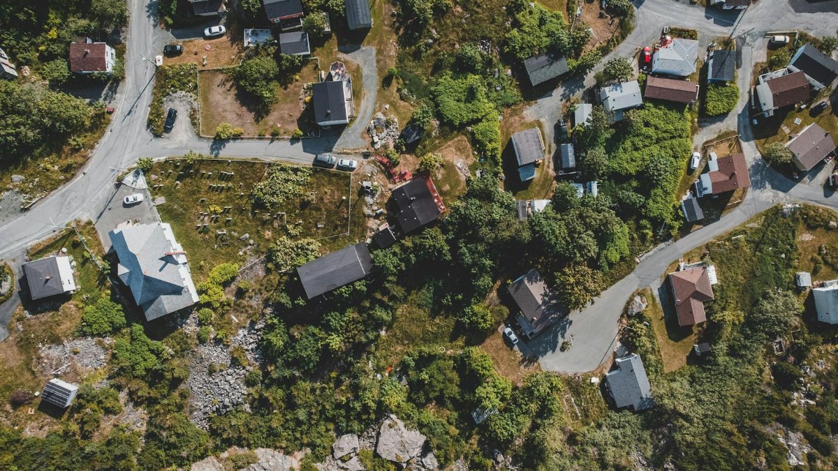 Aerial photo showcasing a picturesque rural neighborhood with roads and greenery.