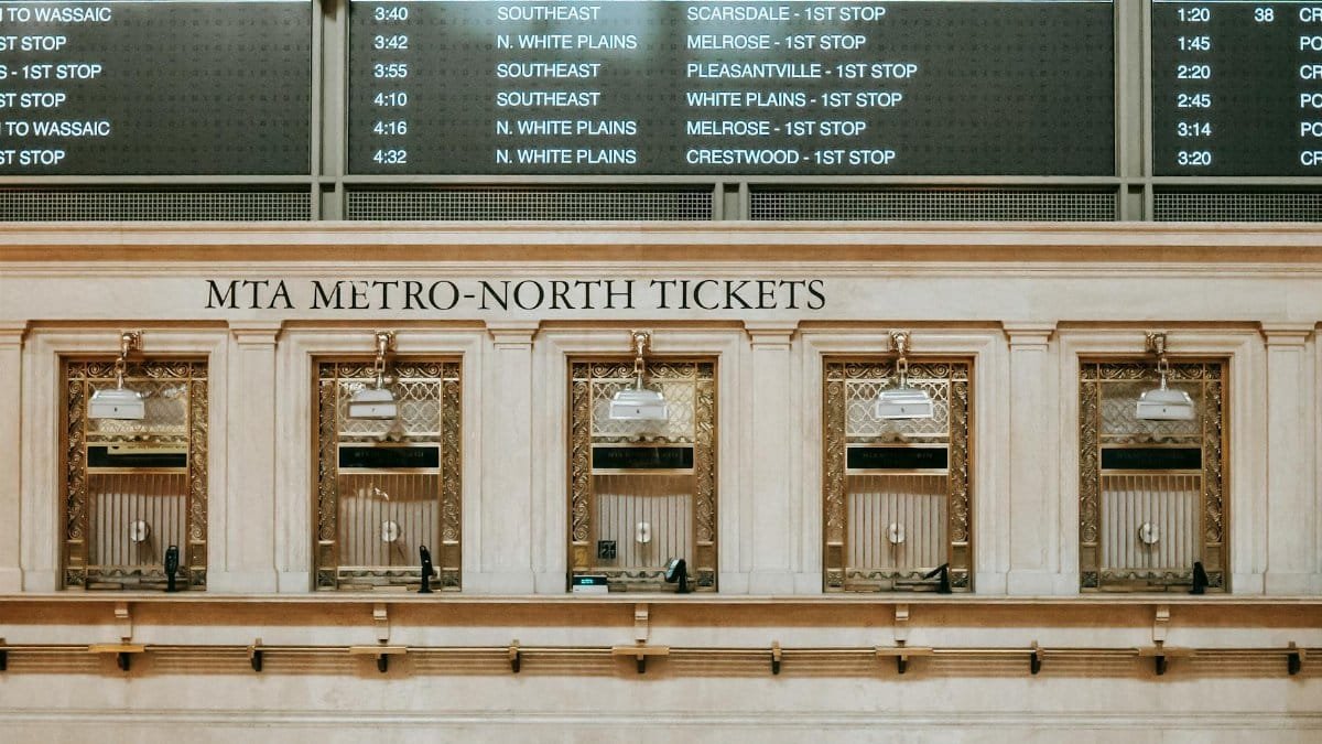 Interior of old box office with golden details under schedule in Grand Central Terminal