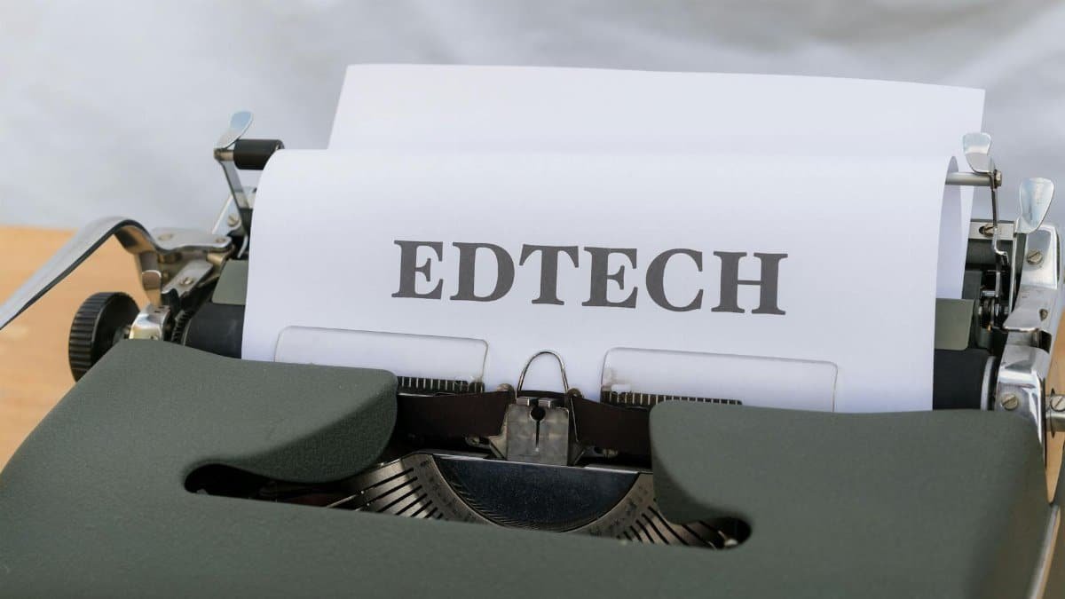 A vintage typewriter with a paper labeled 'EDTECH', signifying educational technology.