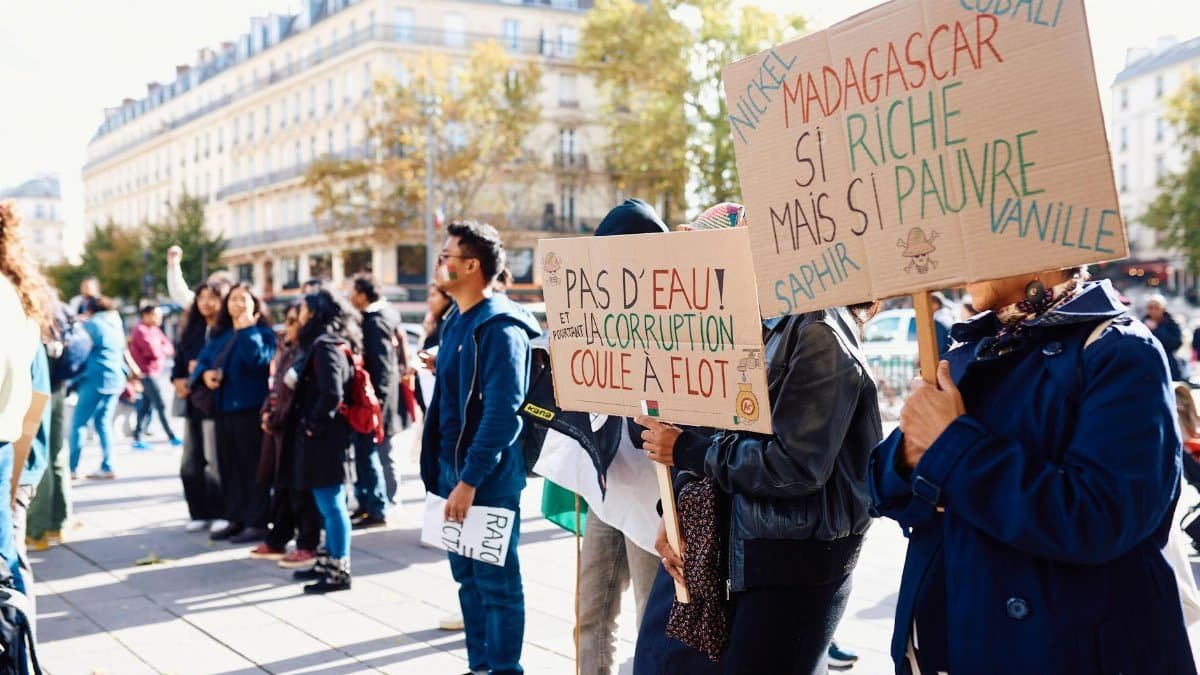 Crowd gathering for a peaceful protest in Paris, raising awareness about Madagascar's political issues.