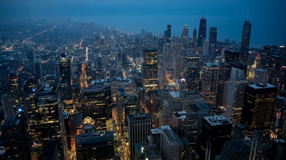 A breathtaking aerial view of Chicago's illuminated skyline transitioning into the evening.