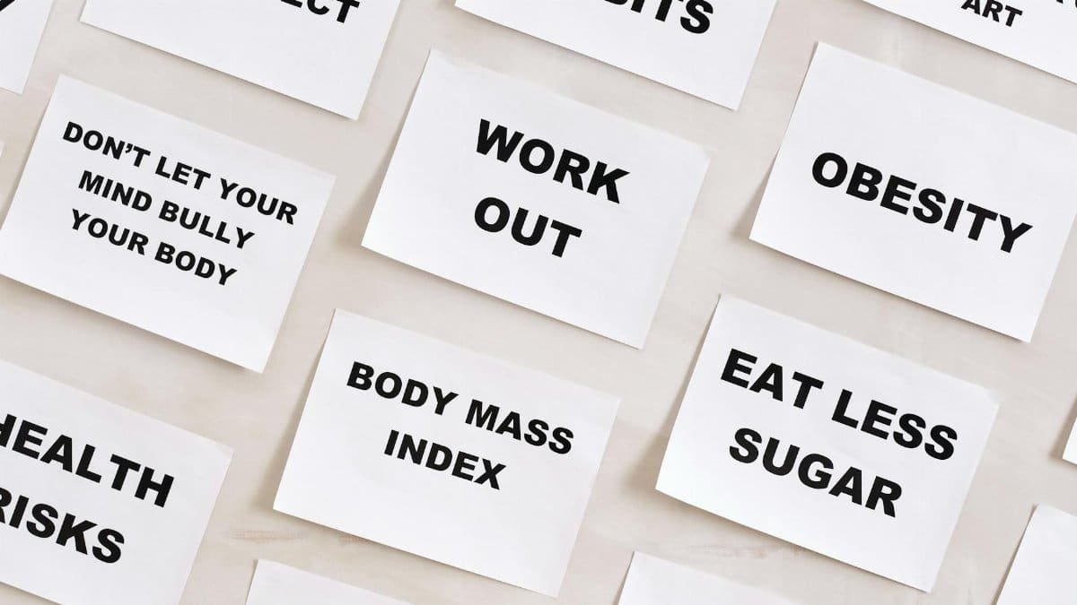 Flat lay of motivational health quotes on paper, promoting healthy habits and self-care.