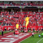 Houston college football match with vibrant crowd and fire effects. Captures the sports spirit.