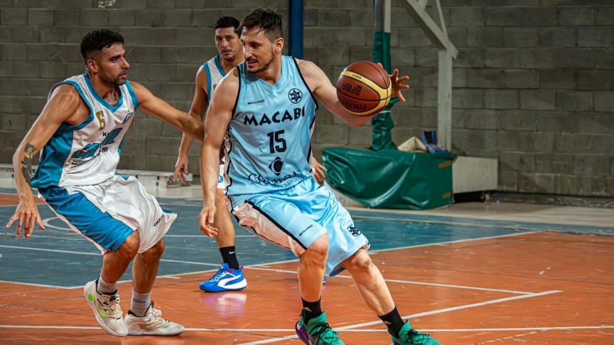 Dynamic shot of basketball players in action during an indoor game.