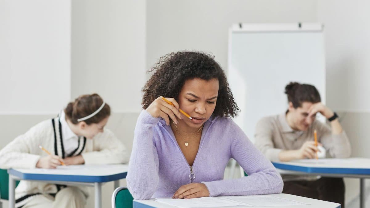 Focused students taking an exam in a classroom setting.