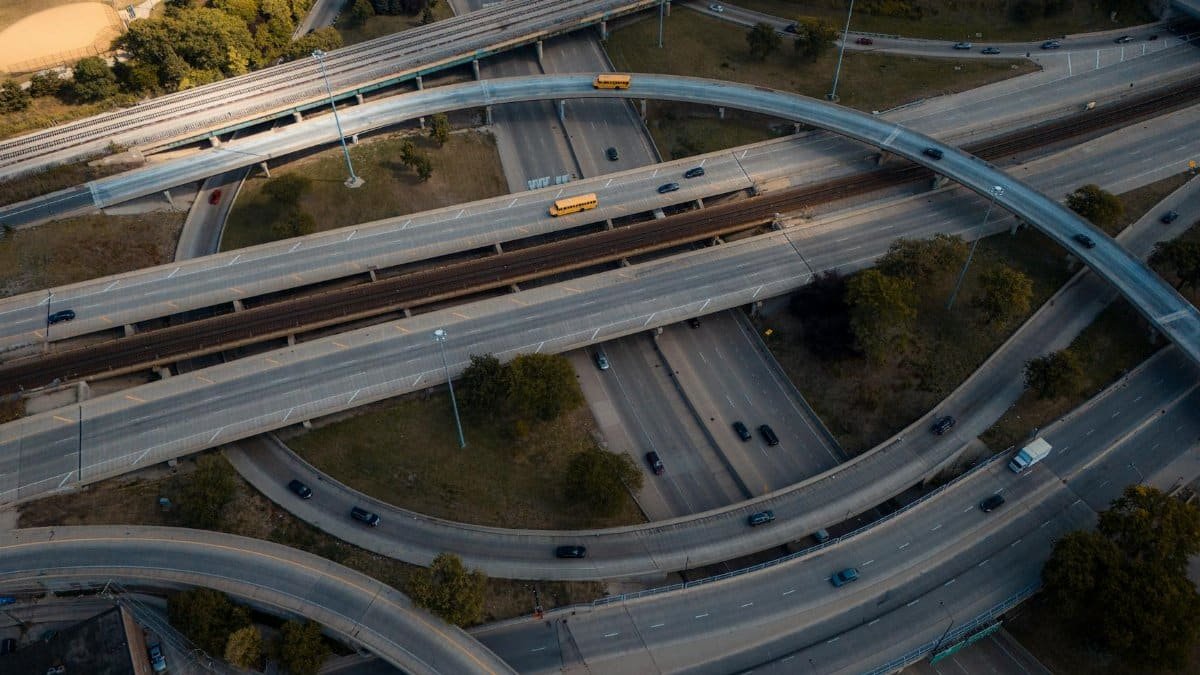 Intricate aerial view of a busy multi-level highway interchange in an urban area.
