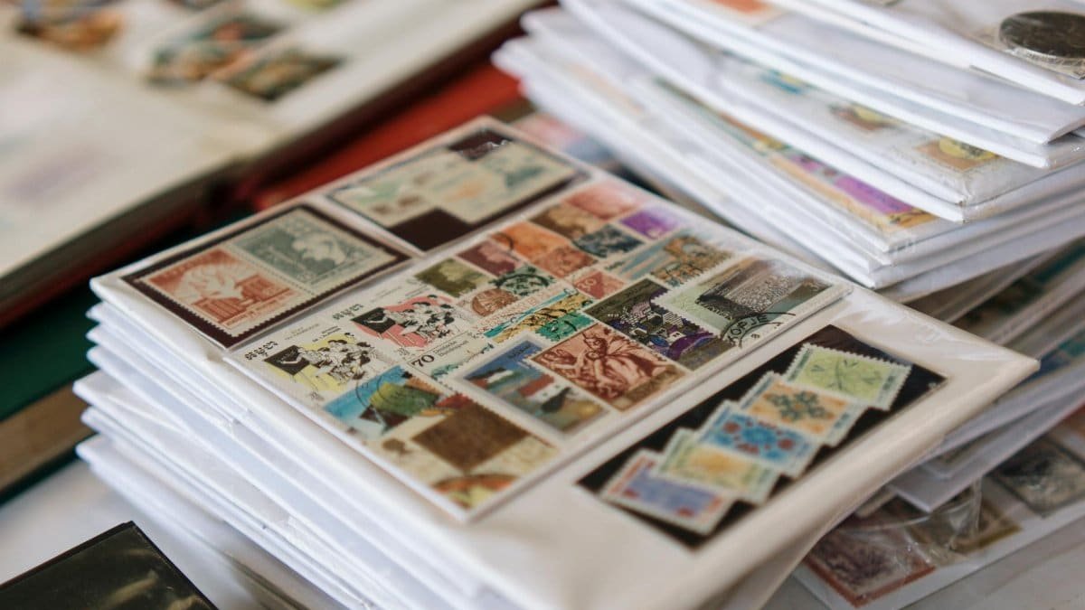 A detailed collection of vintage postage stamps neatly organized in albums, showcasing diverse themes.