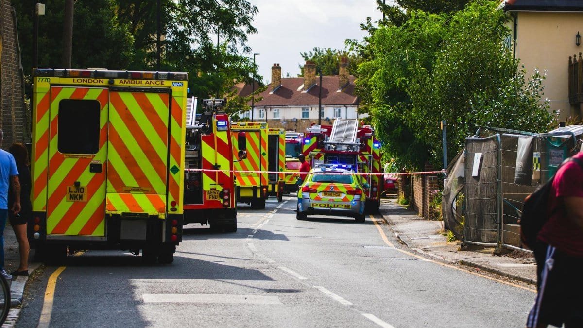 Emergency vehicles respond to an incident on a residential street, road closed.