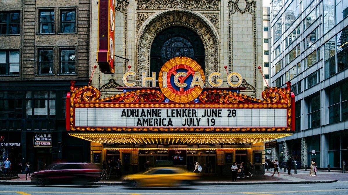 Vibrant Chicago Theater with marquee and busy street, showcasing urban architecture.