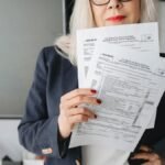 Businesswoman presenting tax documents in a modern office setting.