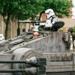 Stormtroopers participating in a cosplay parade featuring a tank-like vehicle in Joliet, IL.