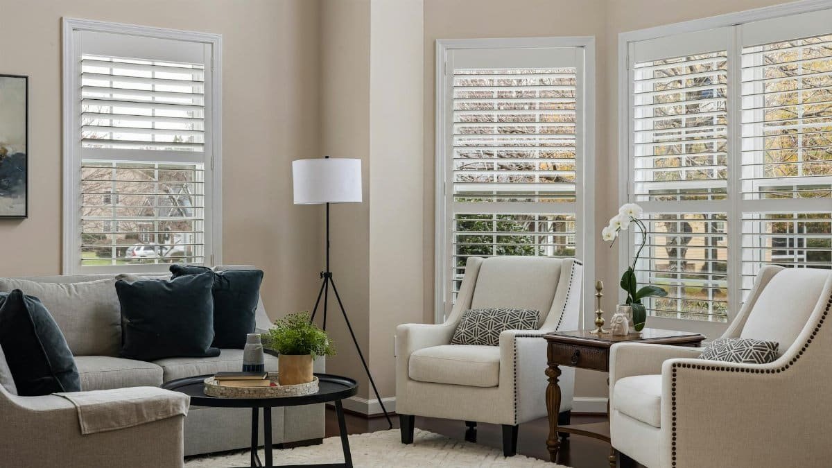 Stylish living room with armchairs, sofa, and soft lighting creating a cozy atmosphere.
