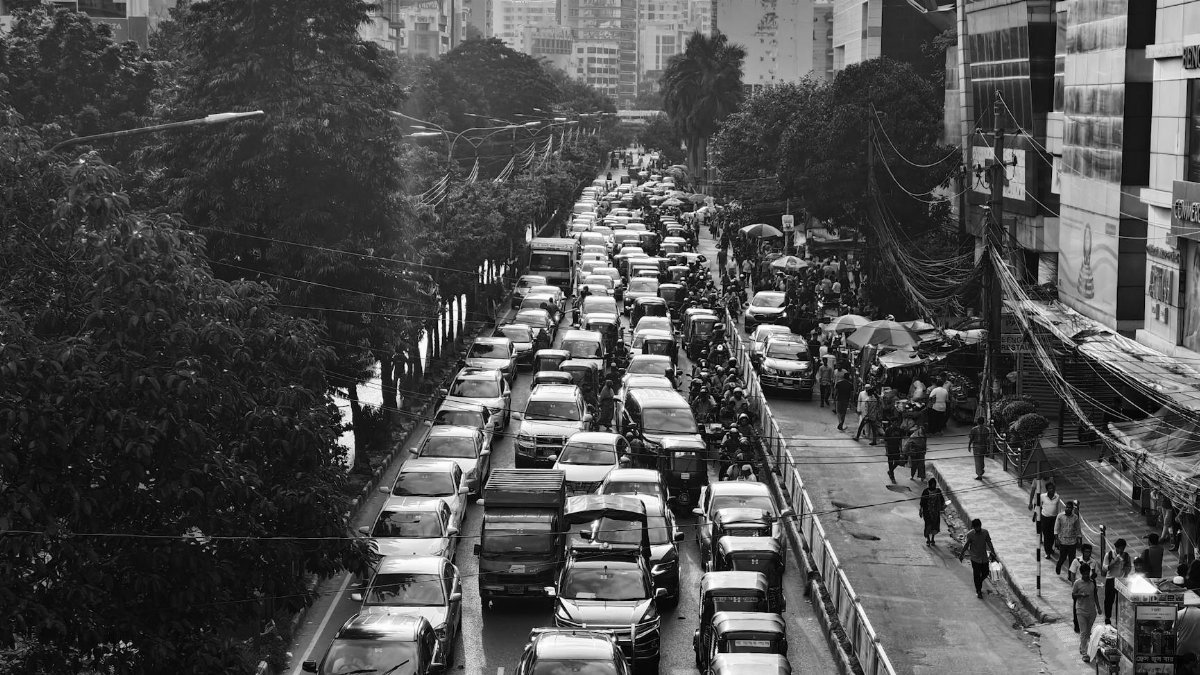 A black and white view of a busy traffic jam in Dhaka, showcasing urban congestion and daily city life.