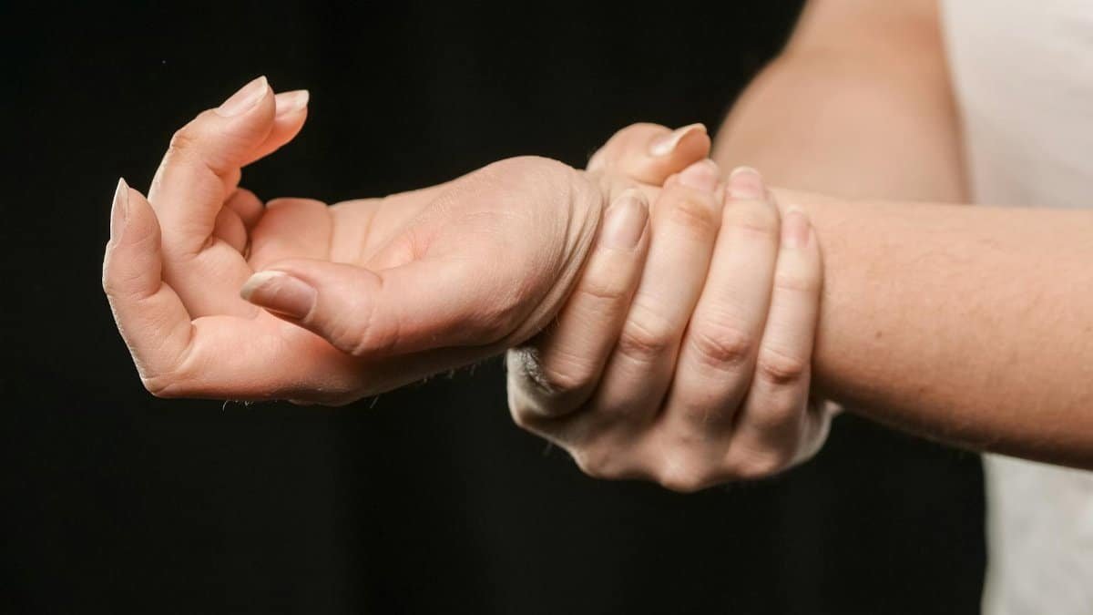 A close-up image of hands grasping a wrist, showcasing human connection and support.