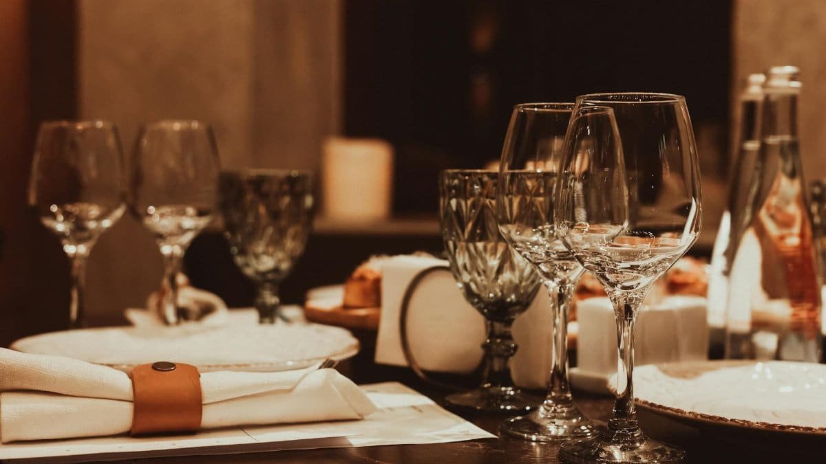 Sophisticated dinner table arrangement with glassware and candlelight for a fine dining experience.