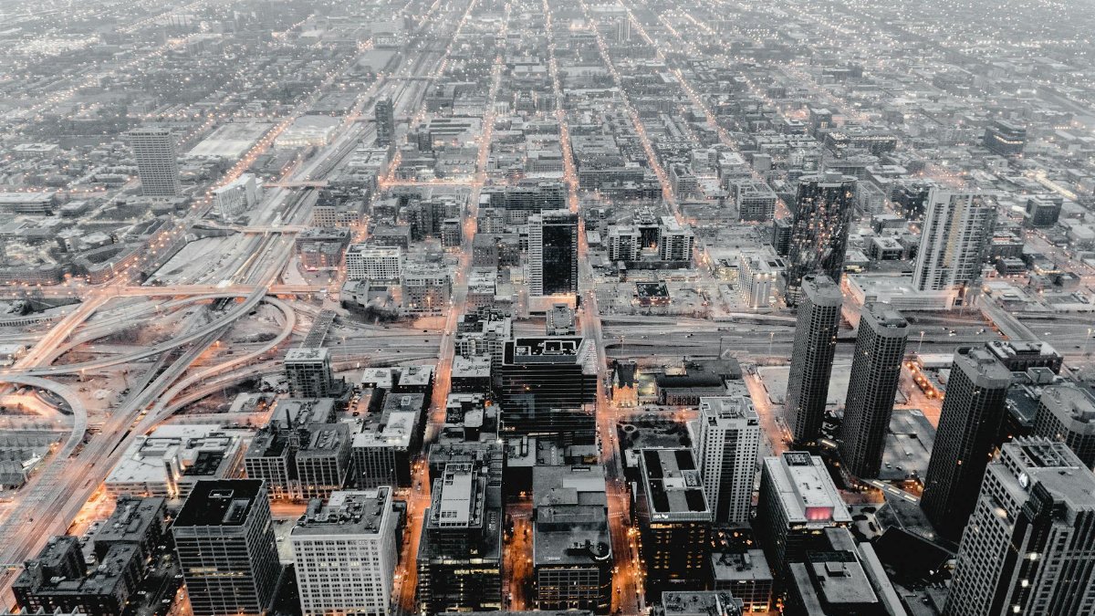 Stunning aerial cityscape of Chicago showcasing its urban structure and illuminated streets at dusk.
