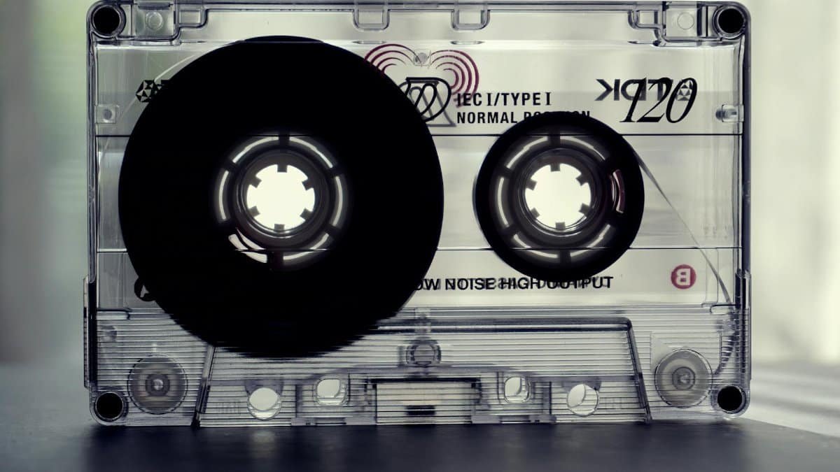 Close-up shot of a vintage cassette tape, highlighting nostalgic retro design and text details.