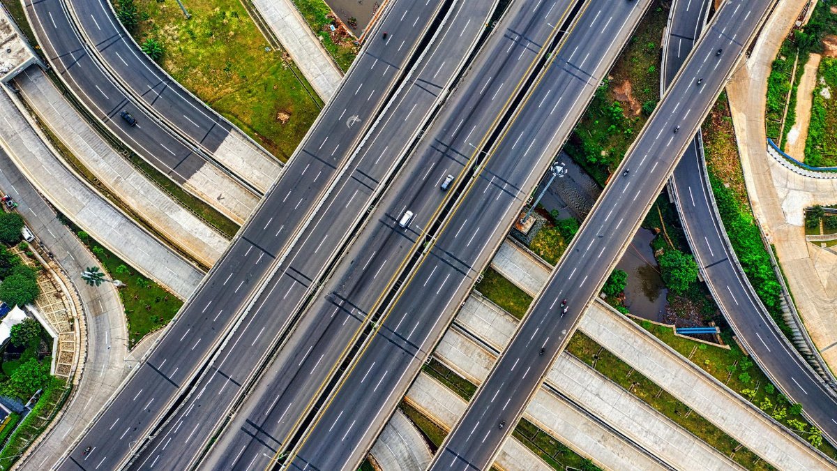 Aerial view of a complex highway interchange in South Jakarta, Indonesia, depicting urban infrastructure.